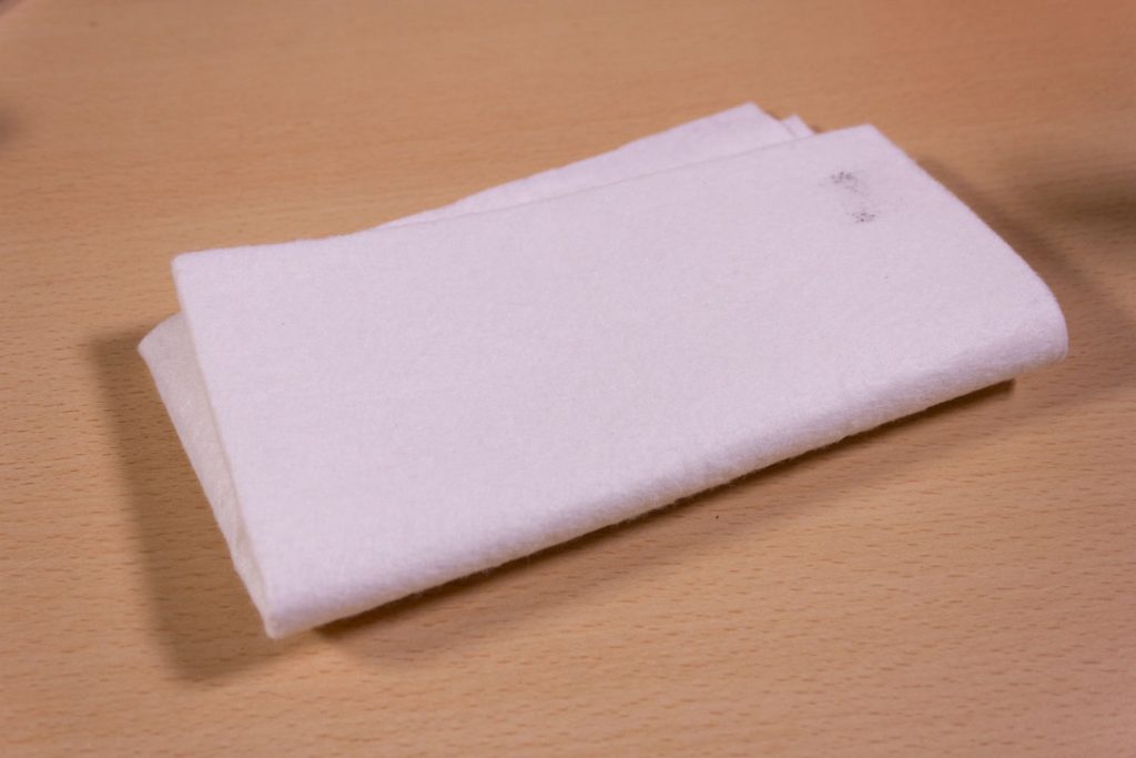 Image shows a piece of cloth on a desk.