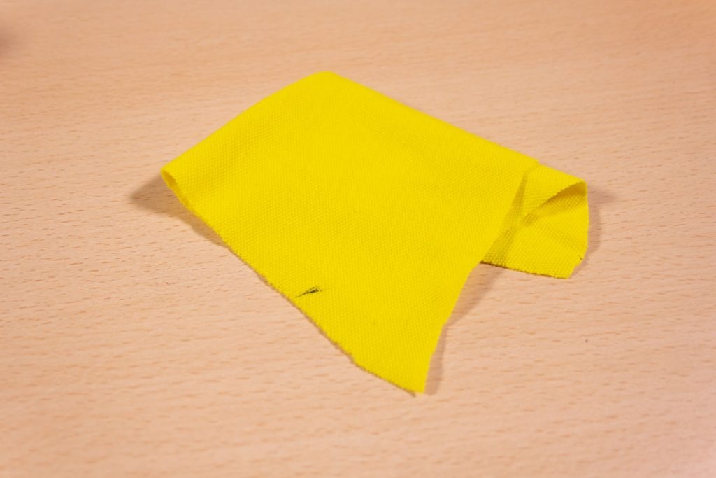 Image shows a part of a polo-shirt on a desk.