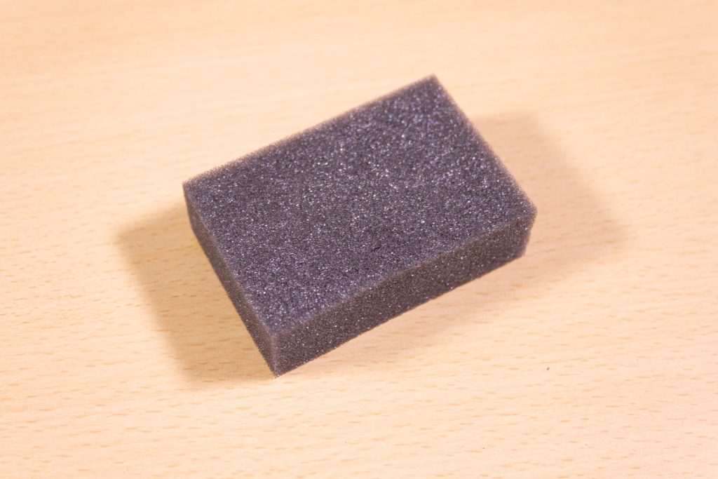 Image shows a foam eraser on a desk.
