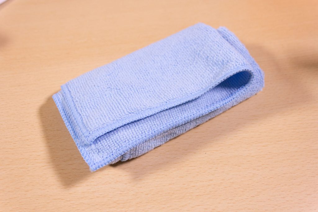 Image shows a microfibre cloth on a desk.