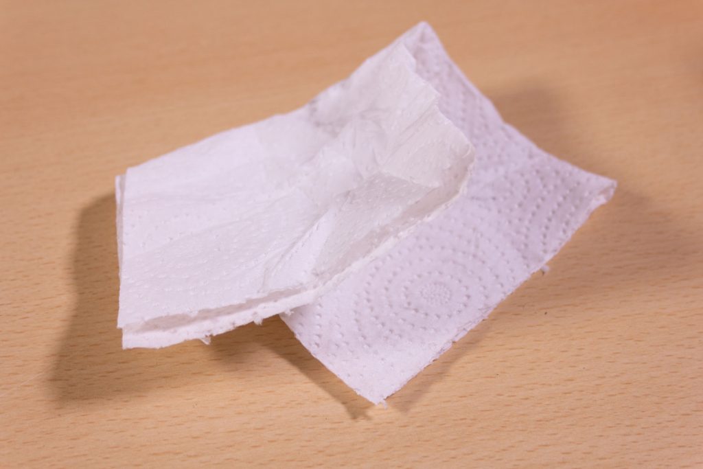 Image shows a piece of kitchen roll on a desk.
